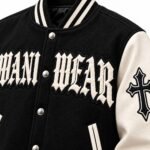 Old English chenille letters and embroidered gothic cross patch on custom streetwear varsity jacket
