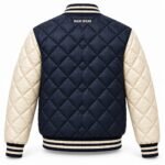 Back view of custom quilted varsity jacket in navy and cream with embroidered neck branding