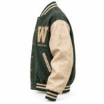 Side profile of distressed wool and leather varsity jacket with brass snaps and striped rib cuffs