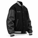 Black wool and leather letterman jacket side view with snap buttons and welt pockets