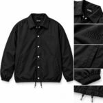 Black custom coach jacket front with snap buttons, collar, tonal embroidery, pocket, cuff and drawcord details by Wani Wear