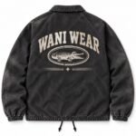 Custom coach jacket back view with large distressed Wani Wear crocodile logo print on vintage washed black twill