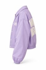 Side view of lavender cropped coach jacket with snap front and puff print branding