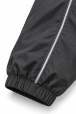 Custom coach jacket sleeve with reflective piping and elastic cuff