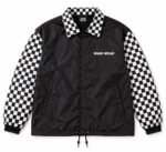 Front of black custom coach jacket with checkered collar and snap buttons