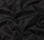 Fabric close-up: Black nylon shell fabric for custom coach jacket