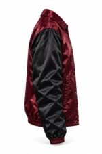 Side profile of custom satin coach jacket showing black sleeve, snap closure and elastic waistband