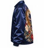 Side view of navy satin coach jacket with tiger and floral embroidery wrapping from the back