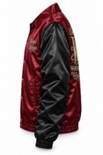 Side view of burgundy custom satin coach jacket with black satin sleeves, script chest embroidery and back crest