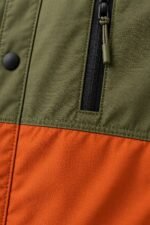Custom coach jacket zippered chest pocket with paracord puller and matte snap button detail