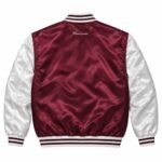 Back of maroon and white satin varsity jacket with embroidered script logo below striped rib collar