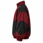 Side view of 90s colorblock track jacket showing dropped shoulder, chevron sleeve panels, and elastic hem