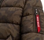 Close-up of MA-1 utility sleeve pocket with red woven Wani Wear zipper tab