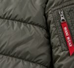 Custom MA-1 bomber jacket sleeve pocket with red Wani Wear zip tag and quilted shell