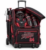 Custom rolling catchers bag in black and red with open top flap showing catcher's helmet, chest protector and leg guards, two bats and Thunder 24 embroidery by Wani Wear