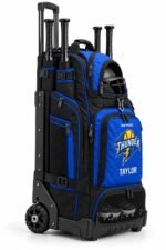 Wheeled softball bat bag side view with extended handle, bat sleeves, helmet pocket and vented cleat compartment