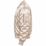 Side profile of a champagne MA-1 satin bomber with zippered sleeve pocket and zip hand pocket