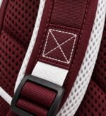 Private label baseball backpack close-up showing box-X reinforced stitching, maroon webbing, white mesh strap lining and ladder buckle