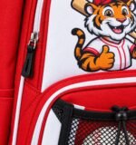 Custom youth baseball backpack close-up with sublimated tiger mascot logo, white piping and drawstring mesh ball pocket